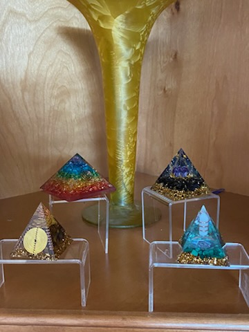 Decorative pyramids arranged on a display shelf