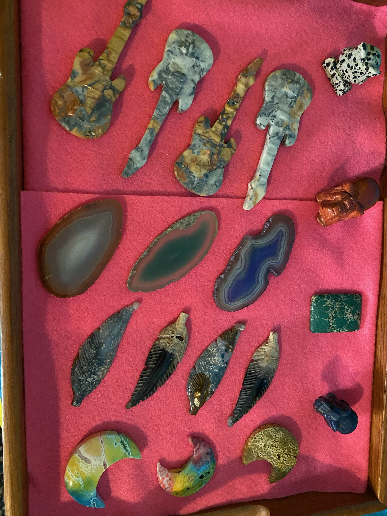 A selection of carved stone hearts, mushrooms, and small animals from Haven’s collection